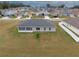 Aerial view of home with gray roof and exterior including a screened in patio and a white fenced yard at 4470 Nw 2Nd Ct, Ocala, FL 34475