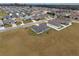 Aerial view of suburban homes with well-maintained lawns and a gray home with a screened in patio at 4470 Nw 2Nd Ct, Ocala, FL 34475