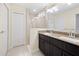 Bathroom featuring granite countertop, stylish vanity, a frameless shower with tiles, and a large mirror at 4470 Nw 2Nd Ct, Ocala, FL 34475