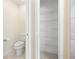 Bathroom with a toilet and a large closet featuring multiple shelves for storage at 4470 Nw 2Nd Ct, Ocala, FL 34475