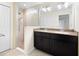 Bathroom featuring granite countertop, stylish vanity, a frameless shower, and a large mirror at 4470 Nw 2Nd Ct, Ocala, FL 34475