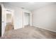 Bright and airy bedroom featuring plush carpet, closet, and a door leading to an adjacent room at 4470 Nw 2Nd Ct, Ocala, FL 34475