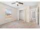 Bright bedroom featuring neutral walls, plush carpet, a window, ceiling fan, and a spacious closet at 4470 Nw 2Nd Ct, Ocala, FL 34475