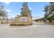 Elegant community entrance with stone signage, wrought iron gates, and manicured landscaping at 4470 Nw 2Nd Ct, Ocala, FL 34475