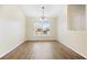 Bright dining room featuring wood-look floors, a modern chandelier, and large window at 4470 Nw 2Nd Ct, Ocala, FL 34475