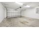 Spacious garage with a roll-up door, concrete flooring, and ample room for vehicles and storage at 4470 Nw 2Nd Ct, Ocala, FL 34475