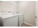 Functional laundry area with washer, dryer, and overhead shelving for storage at 4470 Nw 2Nd Ct, Ocala, FL 34475