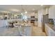 Bright kitchen and breakfast nook featuring modern cabinets, stainless steel appliances, and a large island at 4760 Nw 39Th Street Rd, Ocala, FL 34482