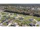 An aerial view of houses with fenced yards surrounded by trees and green grass at 6215 Se 13Th St, Ocala, FL 34472