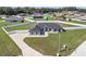 Aerial view of home showcasing large driveway, well-manicured lawn and fenced-in yard at 6215 Se 13Th St, Ocala, FL 34472