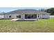 Wide backyard with a well-maintained lawn and a screened lanai at 6215 Se 13Th St, Ocala, FL 34472