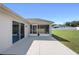 Back of the house with sliding glass doors opening onto concrete and screened-in patio at 6215 Se 13Th St, Ocala, FL 34472