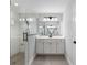 Modern bathroom with a glass shower, white subway tile, and a vanity with double sinks at 6215 Se 13Th St, Ocala, FL 34472