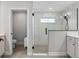 Modern bathroom with a glass-enclosed shower featuring white subway tile and sleek black fixtures at 6215 Se 13Th St, Ocala, FL 34472
