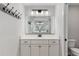 Bathroom vanity featuring double sinks, ample cabinet space, and a large mirror at 6215 Se 13Th St, Ocala, FL 34472