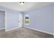 This neutral carpeted bedroom has a large window and white door at 6215 Se 13Th St, Ocala, FL 34472