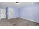 Bedroom boasts plush carpet, two closets, and serene blue walls at 6215 Se 13Th St, Ocala, FL 34472