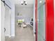 Bright entryway with a red door and a view into the living room featuring a cozy fireplace at 6215 Se 13Th St, Ocala, FL 34472
