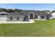 Beautiful single-story home featuring a well-manicured lawn and a striking brick and gray color scheme at 6215 Se 13Th St, Ocala, FL 34472