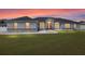 Charming single-story home featuring a well-manicured lawn, elegant brick accents, and a welcoming red front door at 6215 Se 13Th St, Ocala, FL 34472