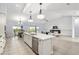 Bright kitchen features stainless appliances, a spacious island with white quartz countertop, and an open floor plan at 6215 Se 13Th St, Ocala, FL 34472