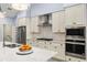 Modern kitchen featuring stainless appliances, white cabinets, herringbone backsplash, and quartz countertops at 6215 Se 13Th St, Ocala, FL 34472