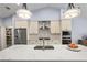 Bright kitchen features stainless steel appliances, a spacious white quartz countertop island, and custom cabinetry at 6215 Se 13Th St, Ocala, FL 34472