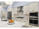 Modern kitchen featuring white cabinets, stainless steel appliances, granite countertops, and a stylish tile backsplash at 6215 Se 13Th St, Ocala, FL 34472
