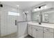 Modern bathroom with a walk-in glass shower with subway tile and dual sink vanity at 6215 Se 13Th St, Ocala, FL 34472