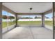 This screened in patio features a neutral finish and views of the yard at 6215 Se 13Th St, Ocala, FL 34472