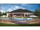 Community pool with lounge chairs and umbrellas at 6238 Sw 93Rd Loop, Ocala, FL 34476