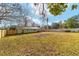 Large backyard with new fence, green grass, and mature trees for privacy at 6302 Nw 57Th Ave, Ocala, FL 34482