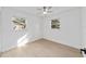 Bright bedroom featuring light wood floors, white walls, and windows at 6302 Nw 57Th Ave, Ocala, FL 34482