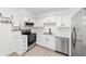 Well-lit kitchen features stainless steel appliances, white cabinets, and granite counters at 6302 Nw 57Th Ave, Ocala, FL 34482