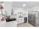 Modern kitchen featuring stainless steel appliances, white cabinetry, and marble countertops at 6302 Nw 57Th Ave, Ocala, FL 34482