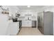 Well-lit kitchen features stainless steel appliances, white cabinets, and granite counters at 6302 Nw 57Th Ave, Ocala, FL 34482