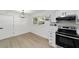 Kitchen featuring stainless steel appliances, modern lighting, and bright, white cabinets at 6302 Nw 57Th Ave, Ocala, FL 34482