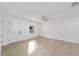 Bright and airy living room with light wood floors, white walls and new ceiling fan at 6302 Nw 57Th Ave, Ocala, FL 34482