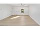 Clean, bright living room featuring light wood floors, white walls, and a ceiling fan at 6302 Nw 57Th Ave, Ocala, FL 34482