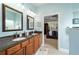 Main bathroom with double vanity, granite countertop, and a view of the bedroom at 7454 Sw 101St Ave, Ocala, FL 34481