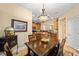 Bright dining room features a wood table and chairs, kitchen view, and globe decor at 7454 Sw 101St Ave, Ocala, FL 34481