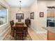 Bright dining room with hardwood floors and a charming chandelier at 7454 Sw 101St Ave, Ocala, FL 34481