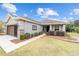 One-story house featuring a brown garage door and well-manicured lawn at 7454 Sw 101St Ave, Ocala, FL 34481