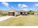 One-story home with brown garage door and lush green lawn at 7454 Sw 101St Ave, Ocala, FL 34481