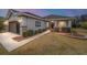 One-story home with brown garage door, landscaping, and walkway at 7454 Sw 101St Ave, Ocala, FL 34481