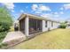 Home exterior showcasing a screened patio and landscaped yard at 7454 Sw 101St Ave, Ocala, FL 34481