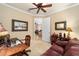 Home office with built-in shelving, wooden desk, and leather couch at 7454 Sw 101St Ave, Ocala, FL 34481