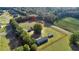 Aerial view of a 1-acre property with a house and fenced paddock at 7601 Se 22Nd Ave, Ocala, FL 34480