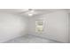 Bedroom featuring a window, ceiling fan, and light gray carpeting at 7601 Se 22Nd Ave, Ocala, FL 34480