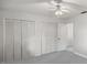 Bedroom with double door closets and ceiling fan at 7601 Se 22Nd Ave, Ocala, FL 34480